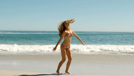 Happy-young-woman-jumping-on-beach-