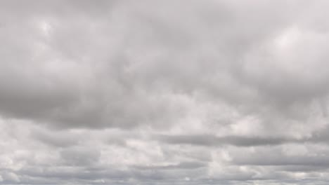 time-lapse of clouds with a car crossing