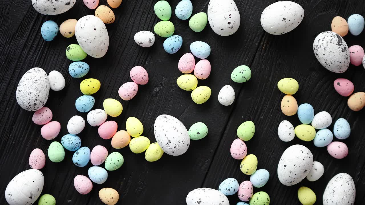 Easter holidays concept  Colorful different kinds of eggs placed on black wood