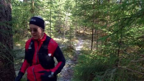 female trailrunner running down a forest single track