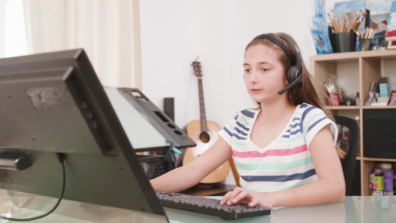 Girl with headset using computer