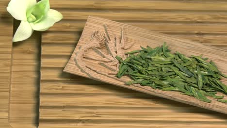 dried green tea on bamboo tray