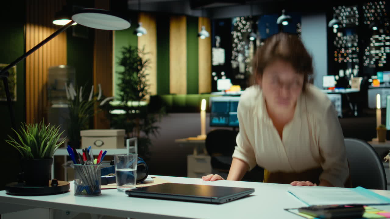 Vertical Video Employee in mental haze turning off the lamp after hours and leaving the office