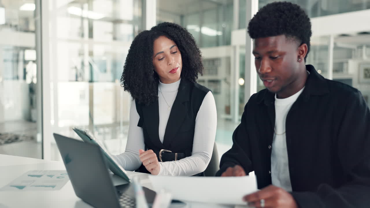 Two business professionals collaborating in a modern office