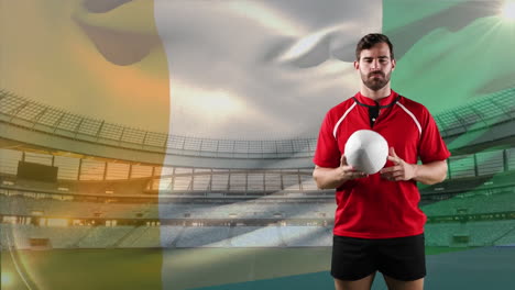 professional rugby player standing in front of a flag and stadium