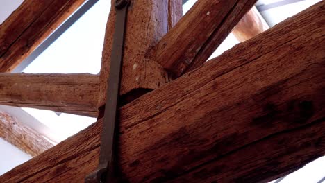 slow orbiting shot showing the wooden structural beams within a castle in france