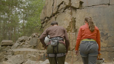 climbers arriving at the bottom of the cliff