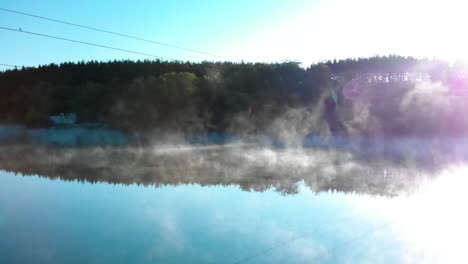 foggy lake and forest after sunrise - panning shot under wires-1