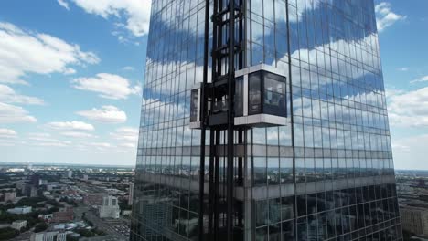 dynamic urban views: a stunning two-frame journey of a modern glass skyscraper with elevators gliding across reflective facades against a bright sky