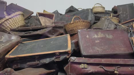 a video showing suitcases and baskets stacked neatly in a pile. a video of suitcases and baskets piled neatly. it shows a collection of luggage and storage containers stacked in an organized manner