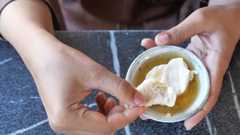 woman eating bread with dip