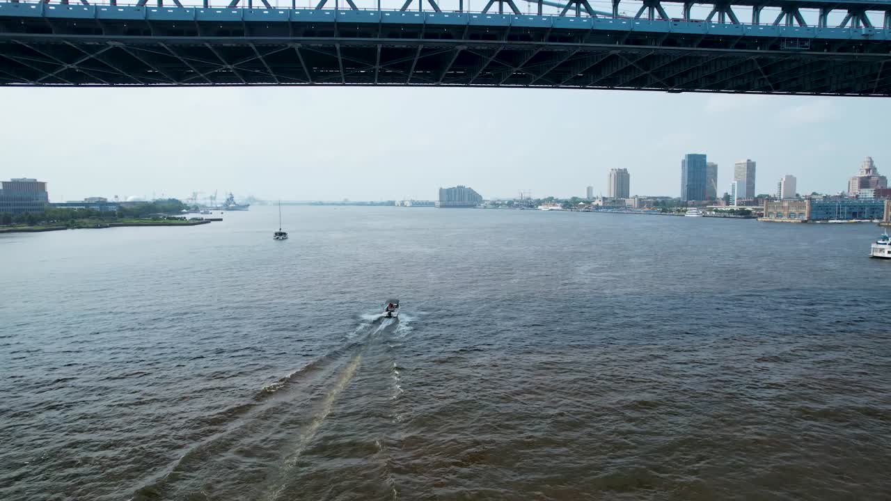 drone following boater under Ben Franklin Bridge Philadelphia