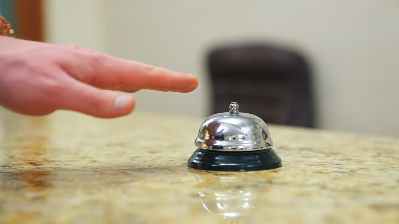 Service bell locating at reception. Customer ringing hotel reception service bell
