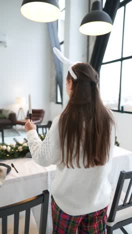 woman preparing a christmas dinner table