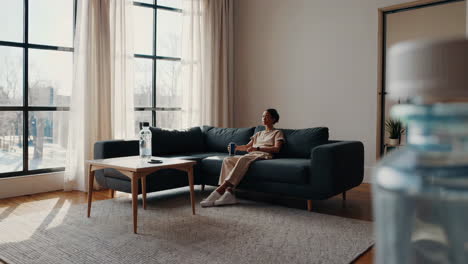 woman relaxing on sofa in modern living room