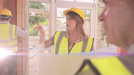 animation of light trails over diverse male and female engineers at building site