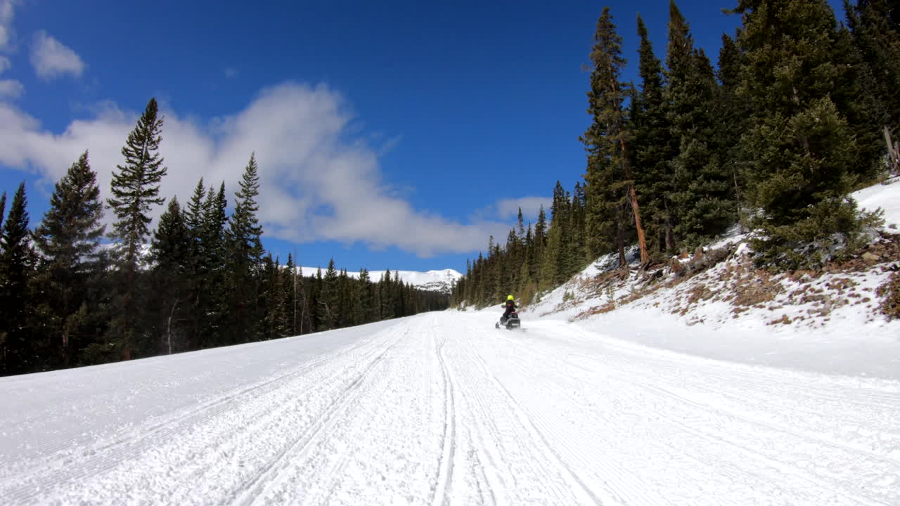 snowmobile in the mountains pov shot