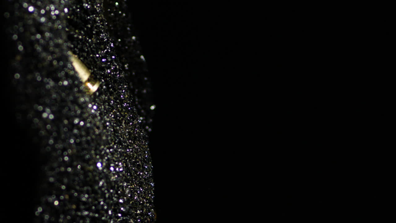 Vista verticale di cartucce 9mm Parabellum che cadono e affondano nella polvere da sparo