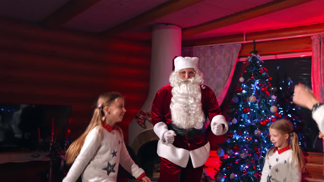 Group of children with Santa Claus. Two little sisters playing at home during Christmas