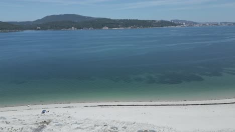 aerial of secluded, not crowded beach off the portugal coast in lisbon, pan right