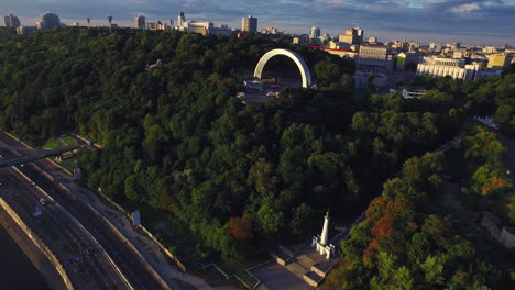 summer park on river embankment in modern city. aerial view urban architecture