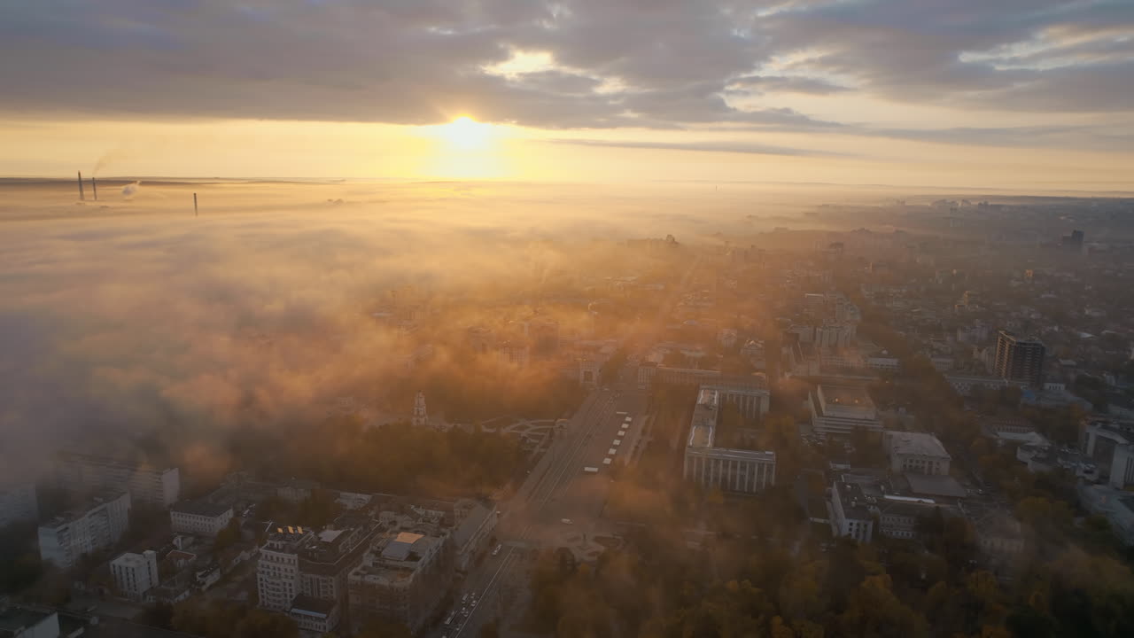 Aerial drone view of Chisinau at sunrise, Moldova. View of city centre covered with fog and low clouds. Central Park, Goverment building