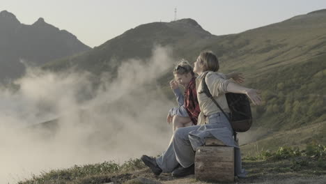 two women enjoying a scenic mountain view