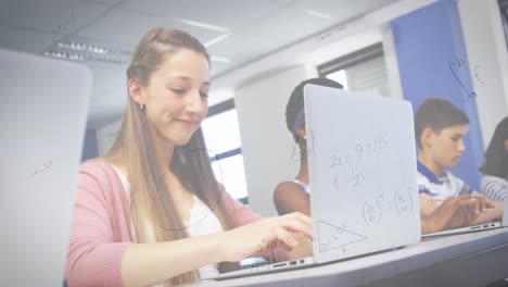 animation of mathematical equations over female student using laptop in classroom