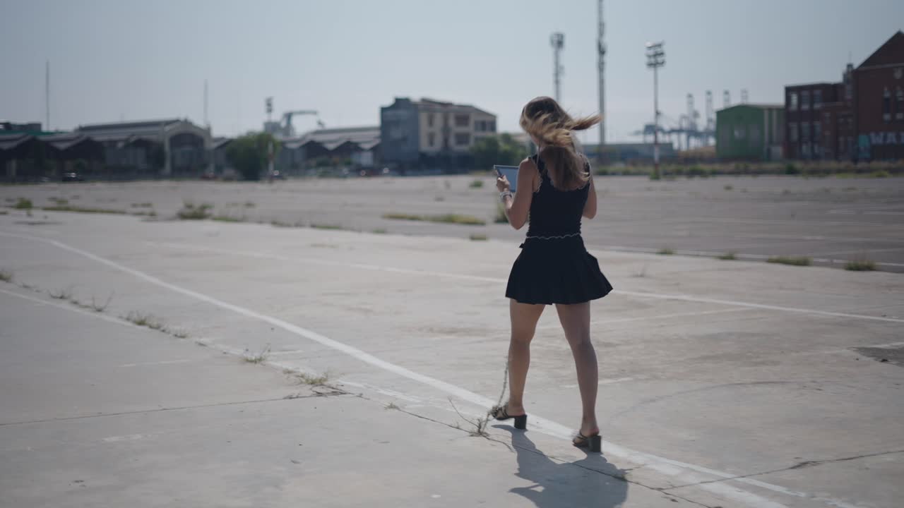Woman Walking in an Empty Urban Lot