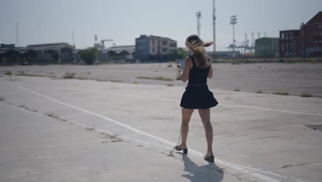 woman walking in an empty urban lot