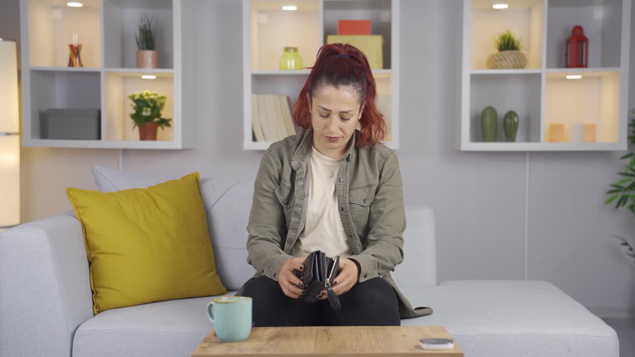 Empty wallet and depressed woman.