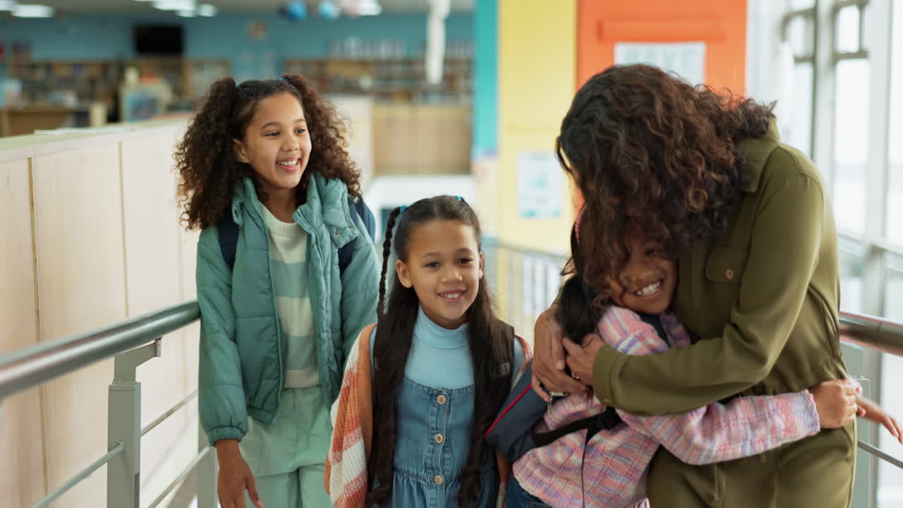 Teacher Hugging Students in School Hallway