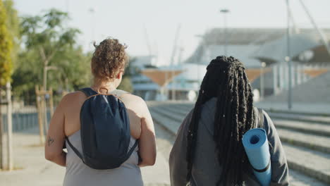 back view of fat women with yoga mat going to training