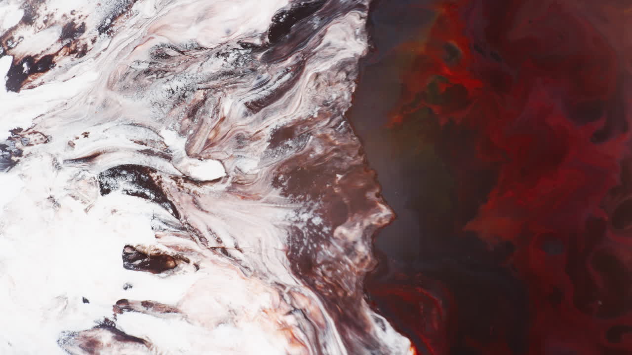 Blowing White And Brown Inks Towards The Red Color To Create Abstract Background