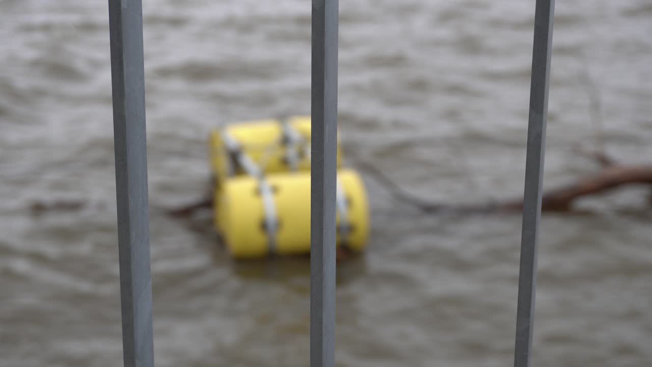 Yellow Barrels Floating in a River