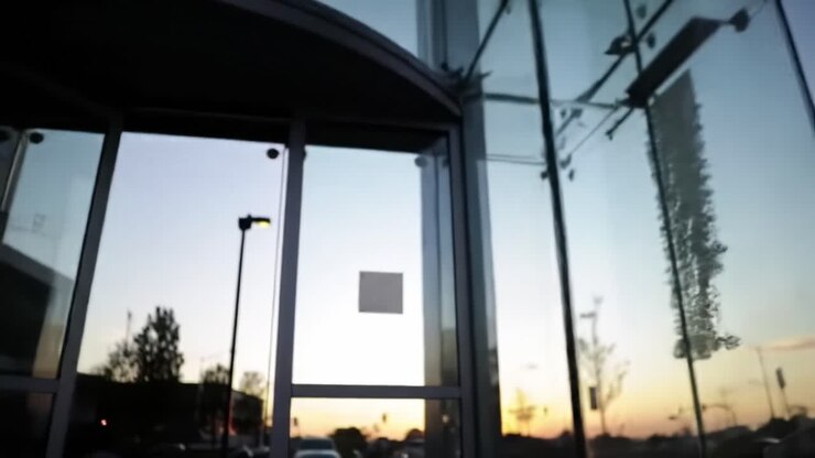 A Sunset Reflection on Modern Glass Architecture: A Serene Evening at a Contemporary Building with Elegant Design and Beautiful Surroundings
