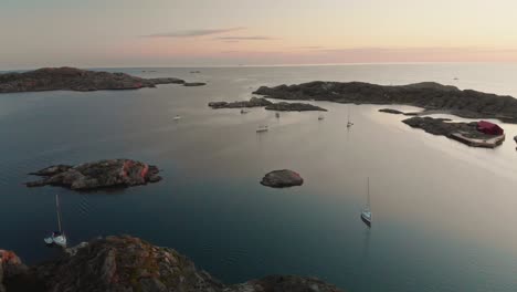 drone flies over swedish archipelago at sunset in skarhamn