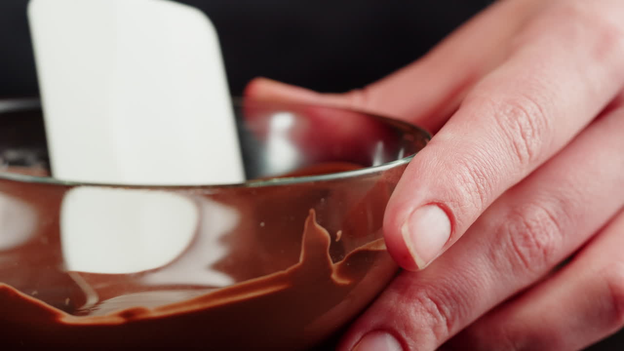 Pouring Melted Chocolate into a Glass Bowl