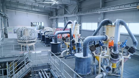 complicated equipment at the modern kaolin processing plant. warehouse with lots of tubes and cisterns connected with each other.