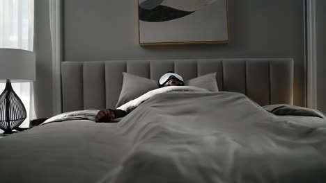 man sleeping in a bed with sleep mask