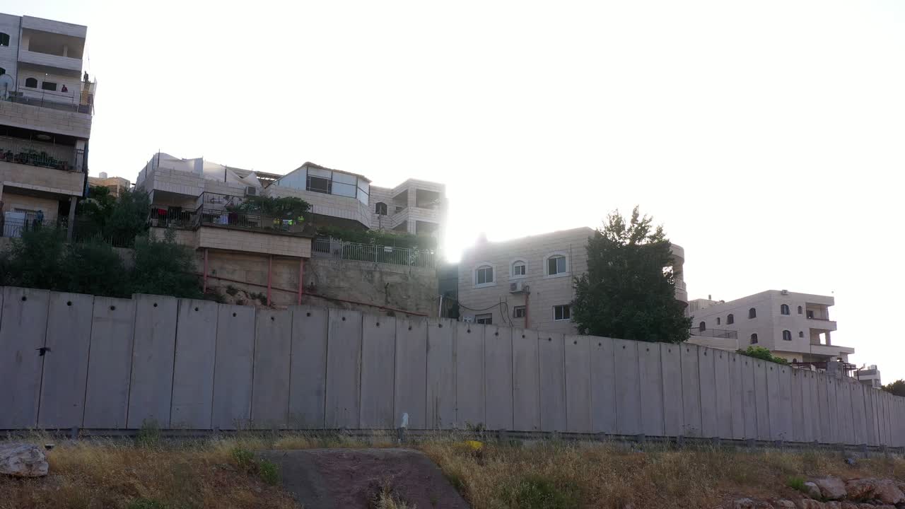 Palestine Refugges Camp Behind Concrete wall with sun flares-aerial