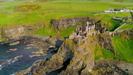 aerial clockwise orbital shot of dunluce castle, northern ireland