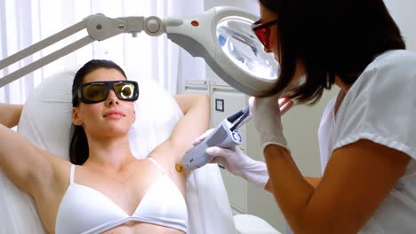 Doctor-performing-laser-hair-removal-on-patient-skin