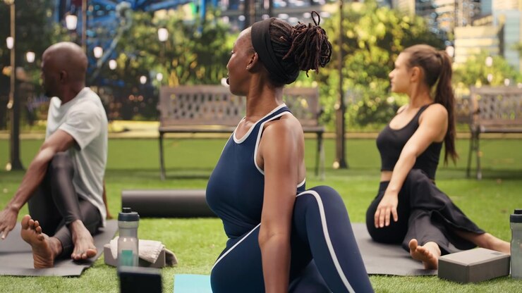 Woman participant performing seated spinal twists and filming video