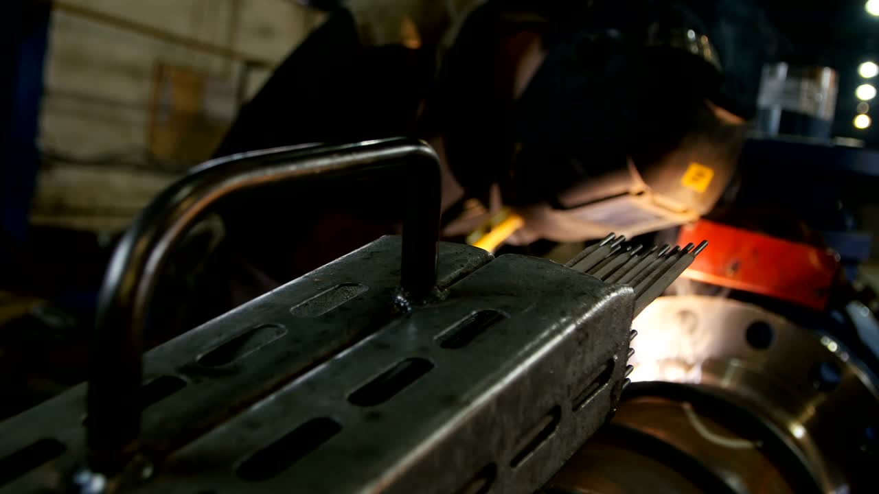 Motion to Worker in Protection Mask Welding Large Metal Pipe