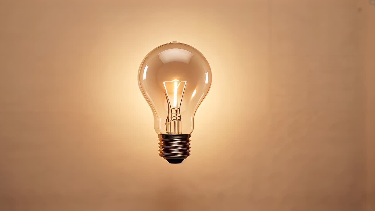 Hanging on thin black wire light bulb receiving current, flickering and heating filament in studio