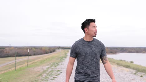 asian-male-walks-towards-camera