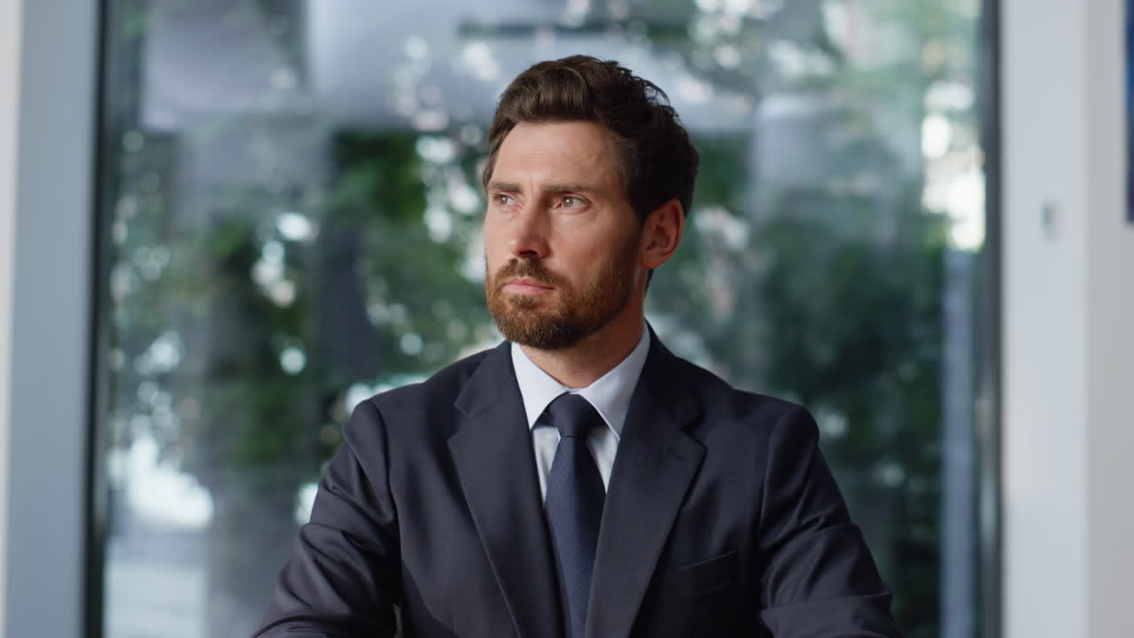 Successful executive sitting cabinet closeup. Bearded businessman looking camera