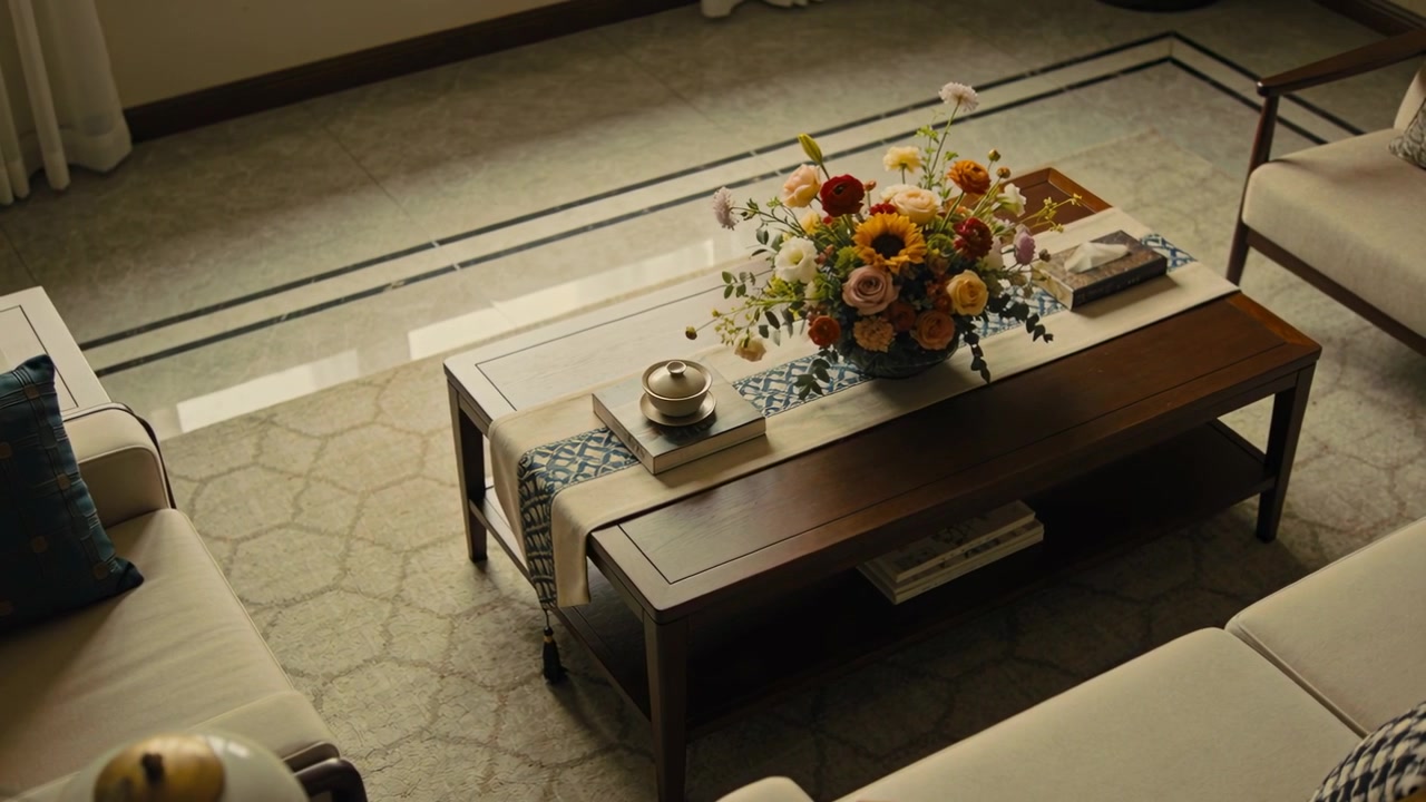 Moving camera bringing wooden coffee table closer in living room, to highlight floral centerpiece