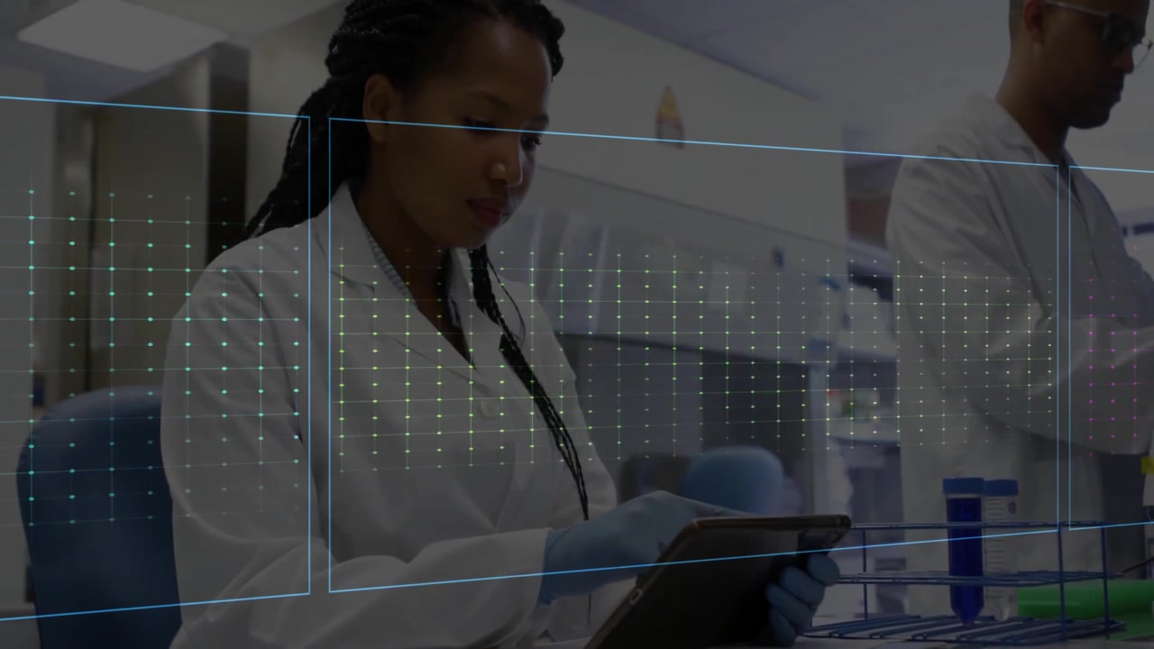 Woman scientist reviewing data on tablet in clinical lab, displaying green and pink ECG waveforms